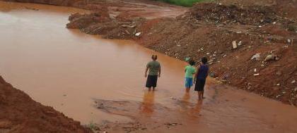 Crianças nadam em cratera de lama  na zona norte