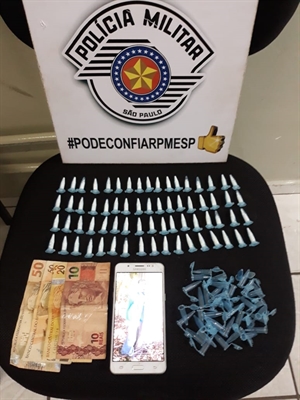 Os policiais da Força Tática apreenderam diversas porções de cocaína, dinheiro, celular e material usado no processo de embalagem (Foto: Divulgação/Força Tática)